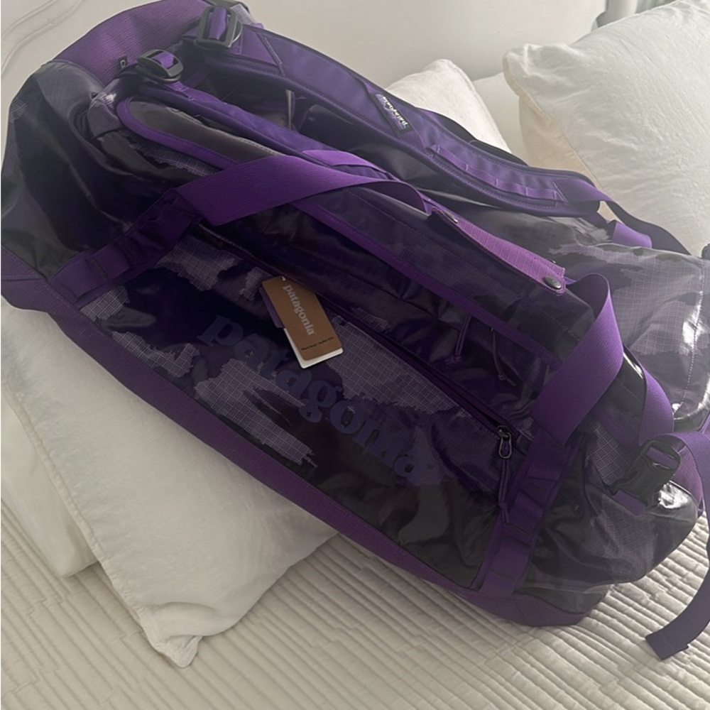 New with tags- Deep purple Camo-Black Hole Duffel-size is 55L